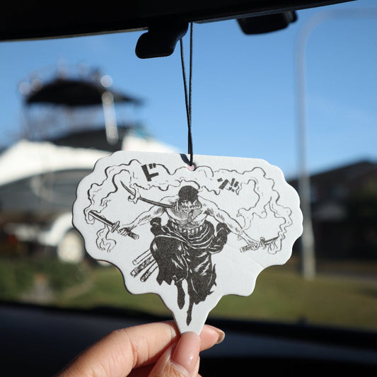 Inspired by the poplar manga and anime series, One Piece, this One Piece Zoro air freshener card design from Entransing's hand drawn artwork, is ideal for adding a touch of style to your car while keeping the air fresh.