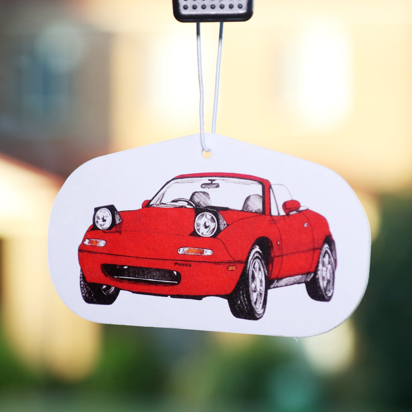 This Mazda Miata MX5 Air Freshener, designed for JDM enthusiasts and Miata lovers. Featuring a stylized design, this air freshener adds a touch of automotive art while keeping your car smelling fresh.