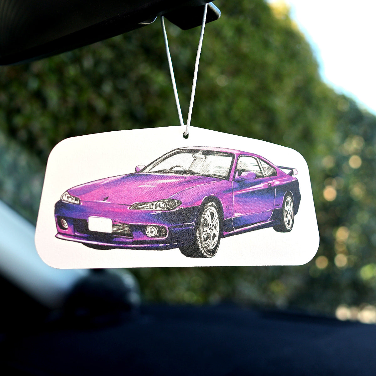 Initial D-inspired Nissan Silvia S15 air freshener hanging from rearview mirror