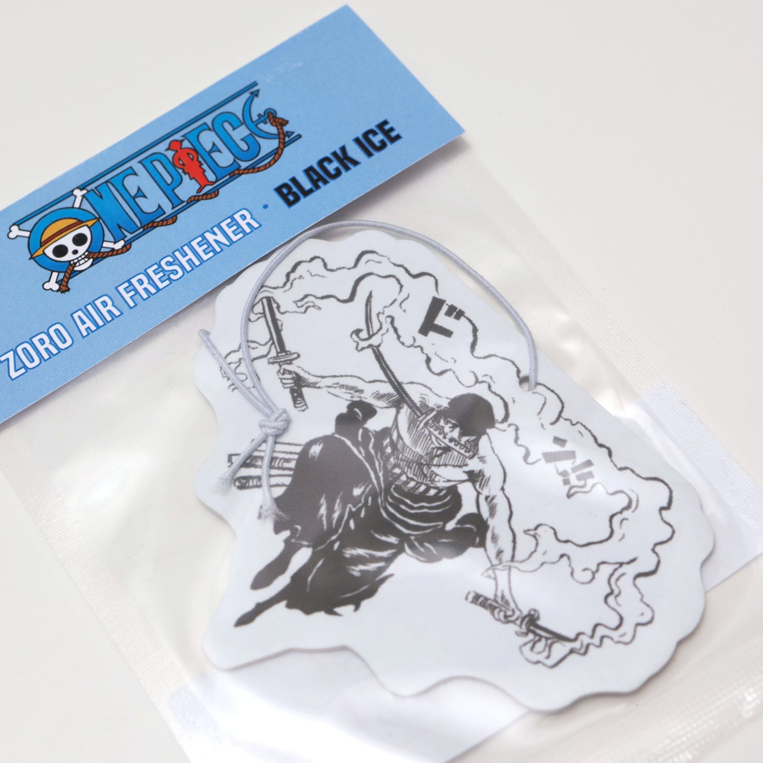 This One Piece Zoro air freshener card Black Ice scent offers a cool, crisp fragrance that keeps your car smelling fresh. Each air freshener comes sealed and includes an elastic tie for easy placement.