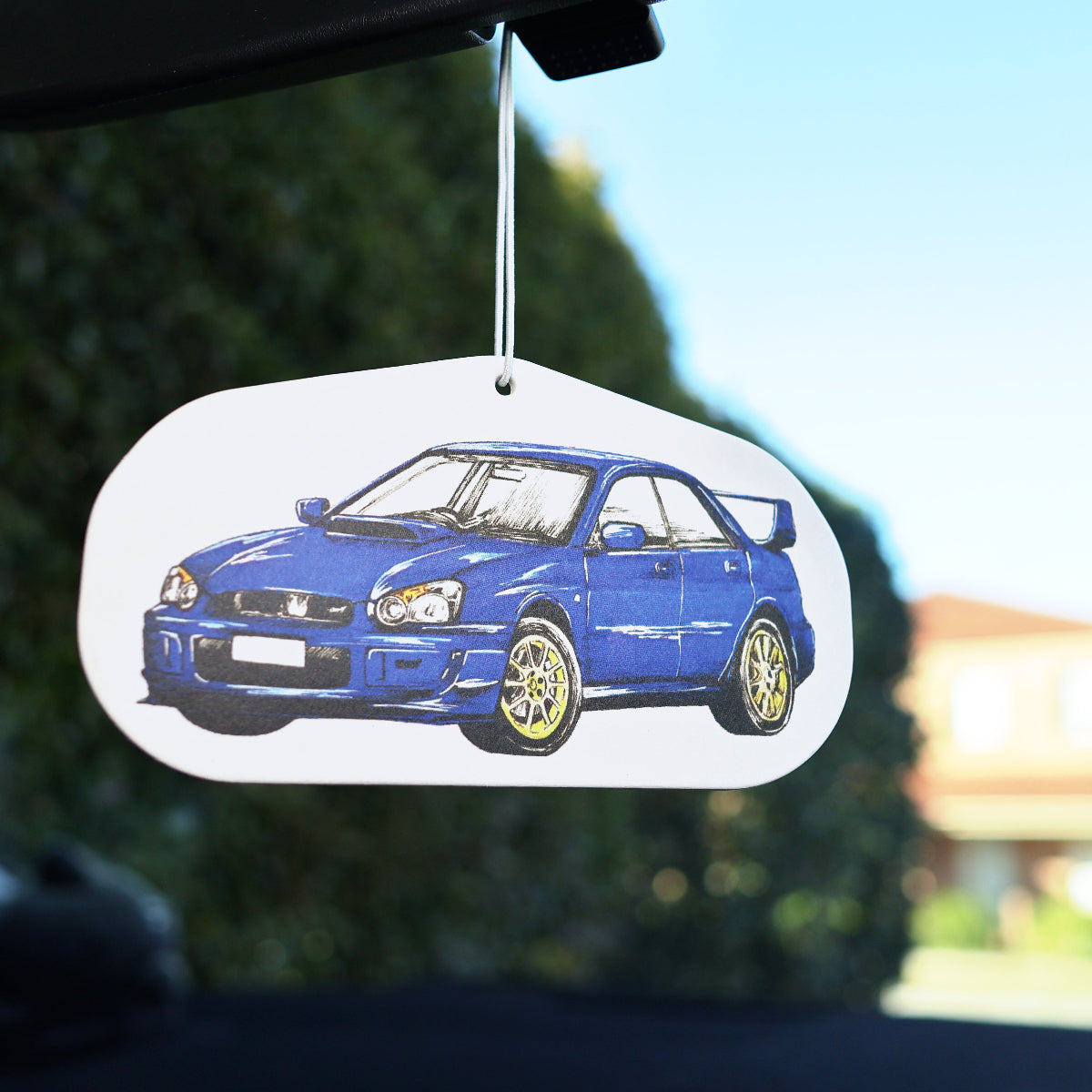 Rally-inspired WRX STi air freshener hanging from rearview mirror