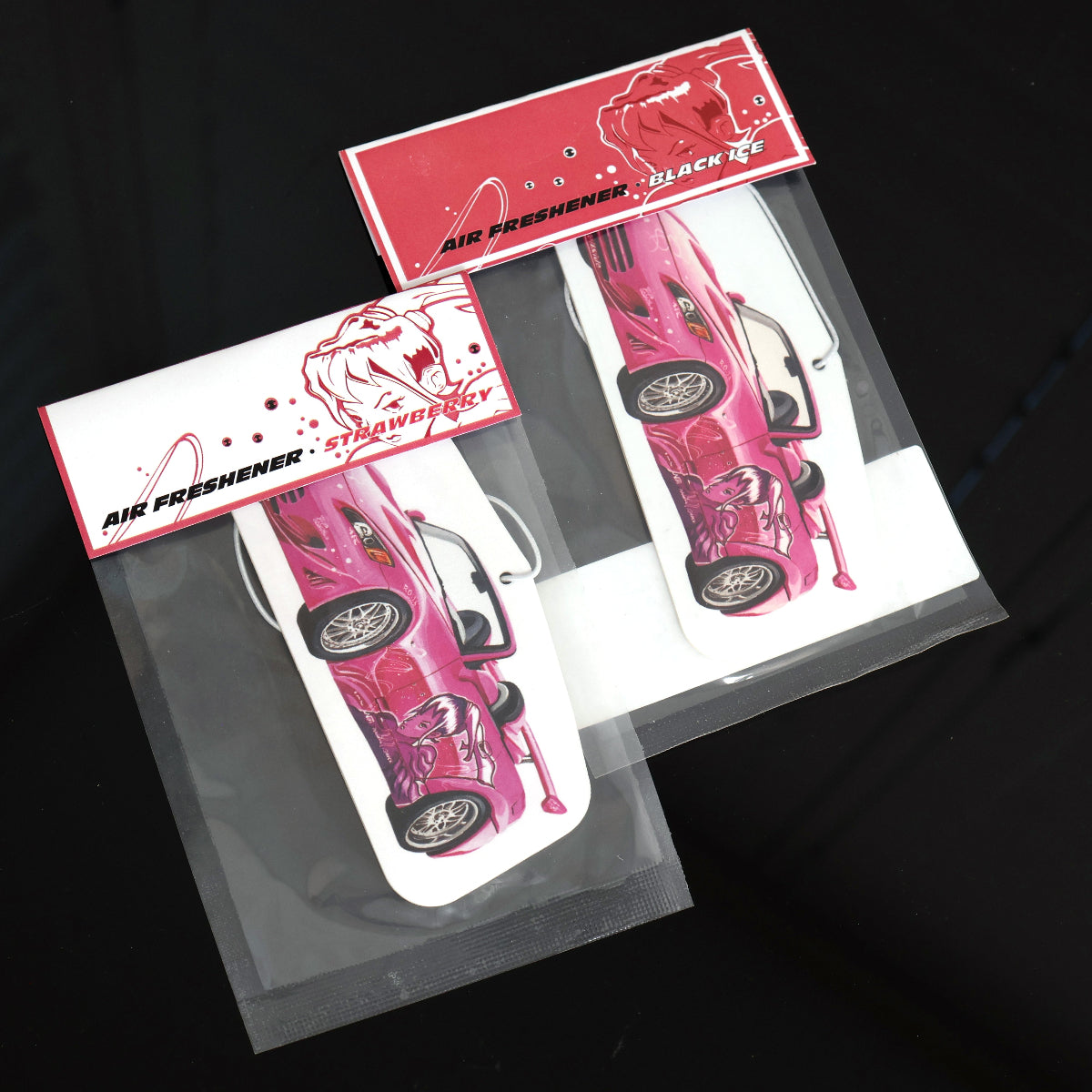 Suki S2000 air freshener card available in Black Ice or Strawberry scent. Each air freshener comes sealed and each includes an elastic tie.