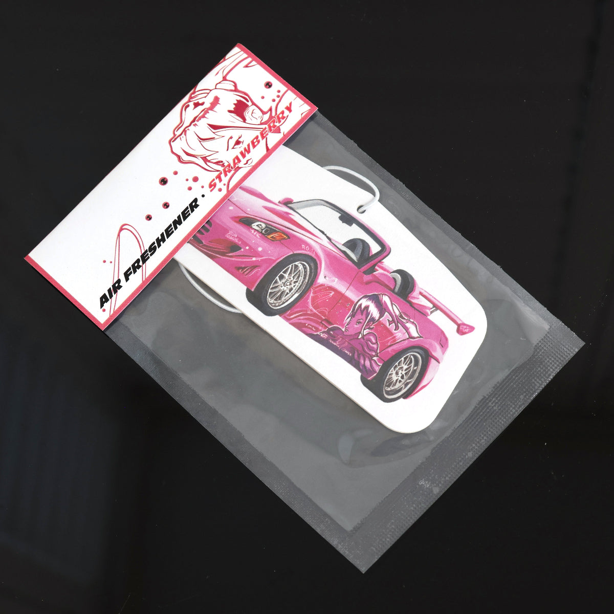 Suki S2000 car air freshener inspired by Fast and Furious, Strawberry, provides a sweet and fruity aroma to uplift your spirits. Each air freshener comes sealed and includes an elastic tie for easy placement.