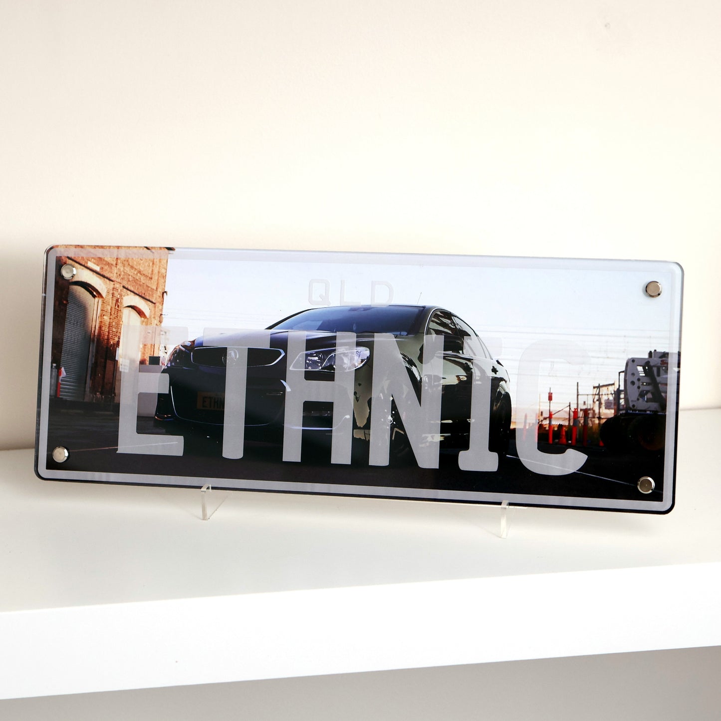 Custom car number plate decor plaque with personalized text and automotive design.