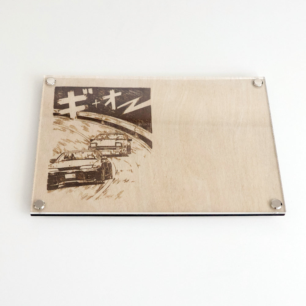 A stylish noting board for all JDM enthusiasts. Laser-engraved manga scene of a Nissan GT-R R32 racing a Toyota AE86 on one side and a blank writing area on the other. The clear acrylic surface allows you to use with whiteboard markers or erasable chalk pens. Dimensions: Standard A5 210 x 148mm | 8.27 x 5.83 inches.