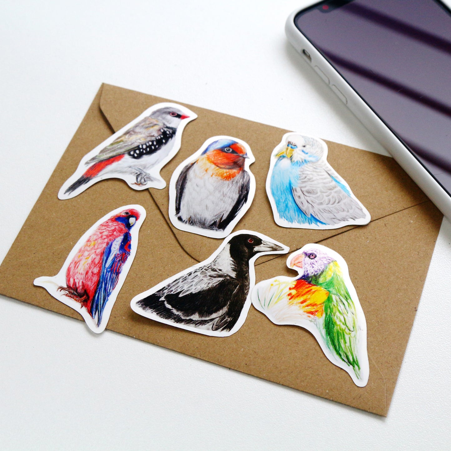 This Australian bird art vinyl stickers pack includes 6 stickers: 1 x Diamond Firetail, 1 x Magpie, 1 x Budgerigar, 1 x Crimson Rosella, 1 x Rainbow Lorikeet, 1 x Welcome Swallow. Made from high quality vinyl, these stickers are beautifully vivid in colour and capture each iconic Australian bird in stunning detail.