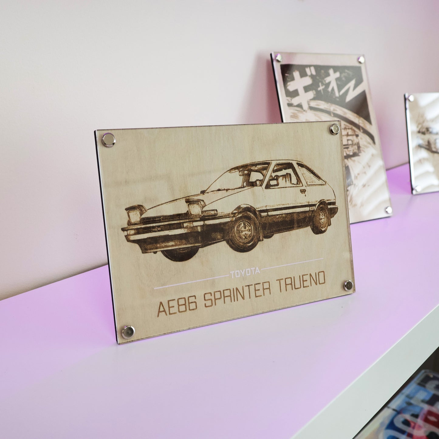 AE86 car art. Laser engraving example of Legendary Toyota AE86 Spinter Trueno. Stand on a white table with Artysn Studio's LayaBoard frame.