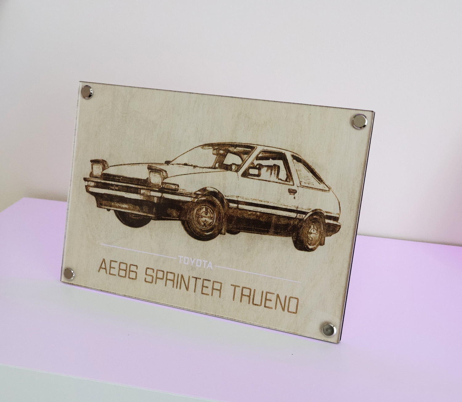 AE86 car art. Laser engraving example of iconic Toyota AE86 Spinter Trueno.  Framed with Artysn Studio Art Display on table with the included stand attachment.