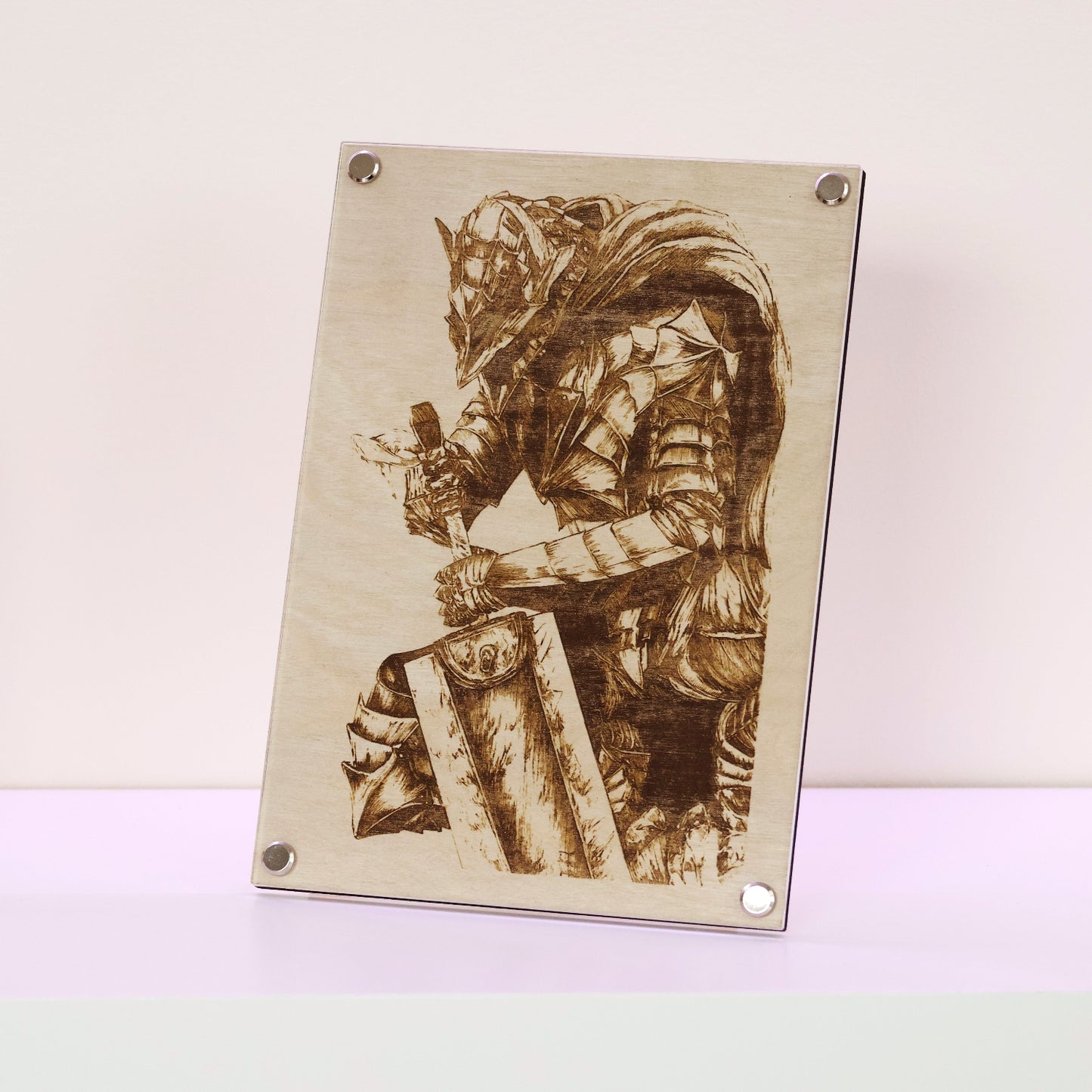 Artysn Studio exclusive laser-engraved plaque, Berserker Armor LayaBoard Art, featuring Guts in his formidable Berserker Armor display on table.