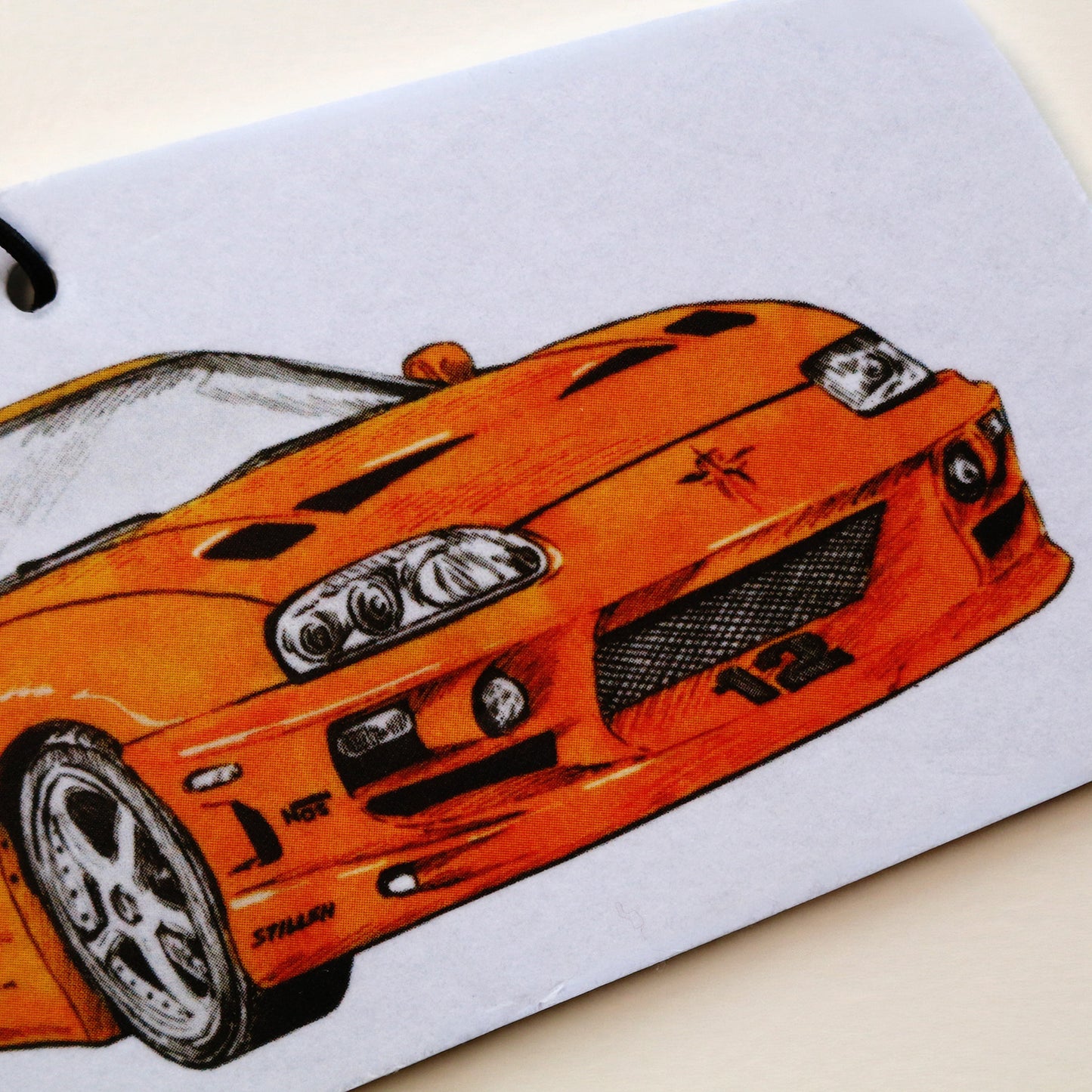 Close‑up of Brian’s MK4 Supra air freshener showing detailed front end artwork.