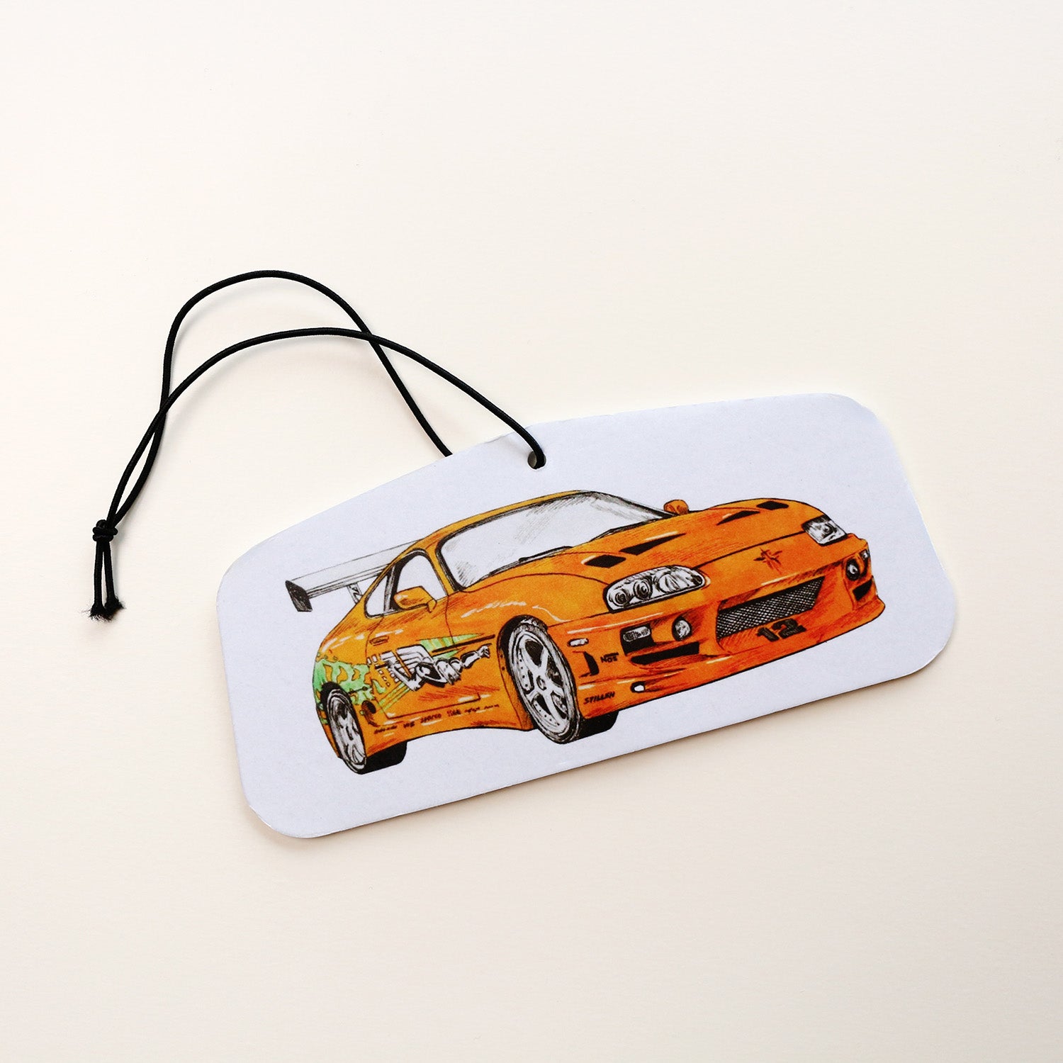 Hand‑drawn Brian’s Toyota Supra MK IV air freshener in orange, front view.