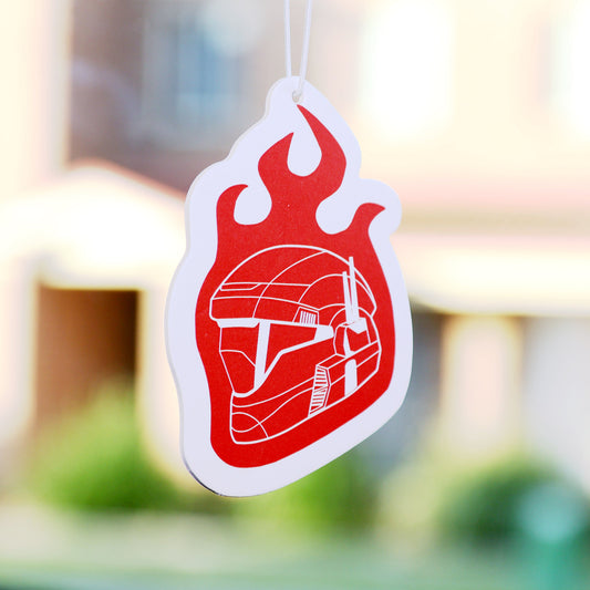 A Halo-inspired air freshener, featuring a hand-drawn illustration, brings a unique interpretation of the ODST aesthetic into all vehicles. This ODST Flame Helmet Air Freshener add a bold touch while keeping the car smelling fresh. 