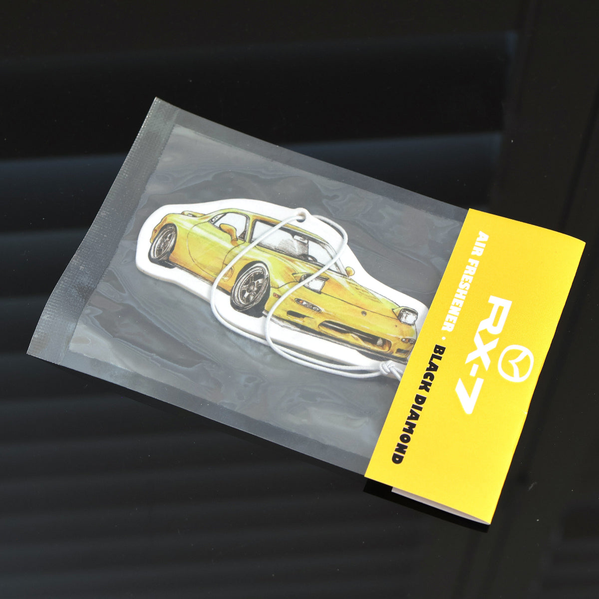 Yellow RX-7 FD air freshener in Black Diamond variant, ideal for rotary car fans