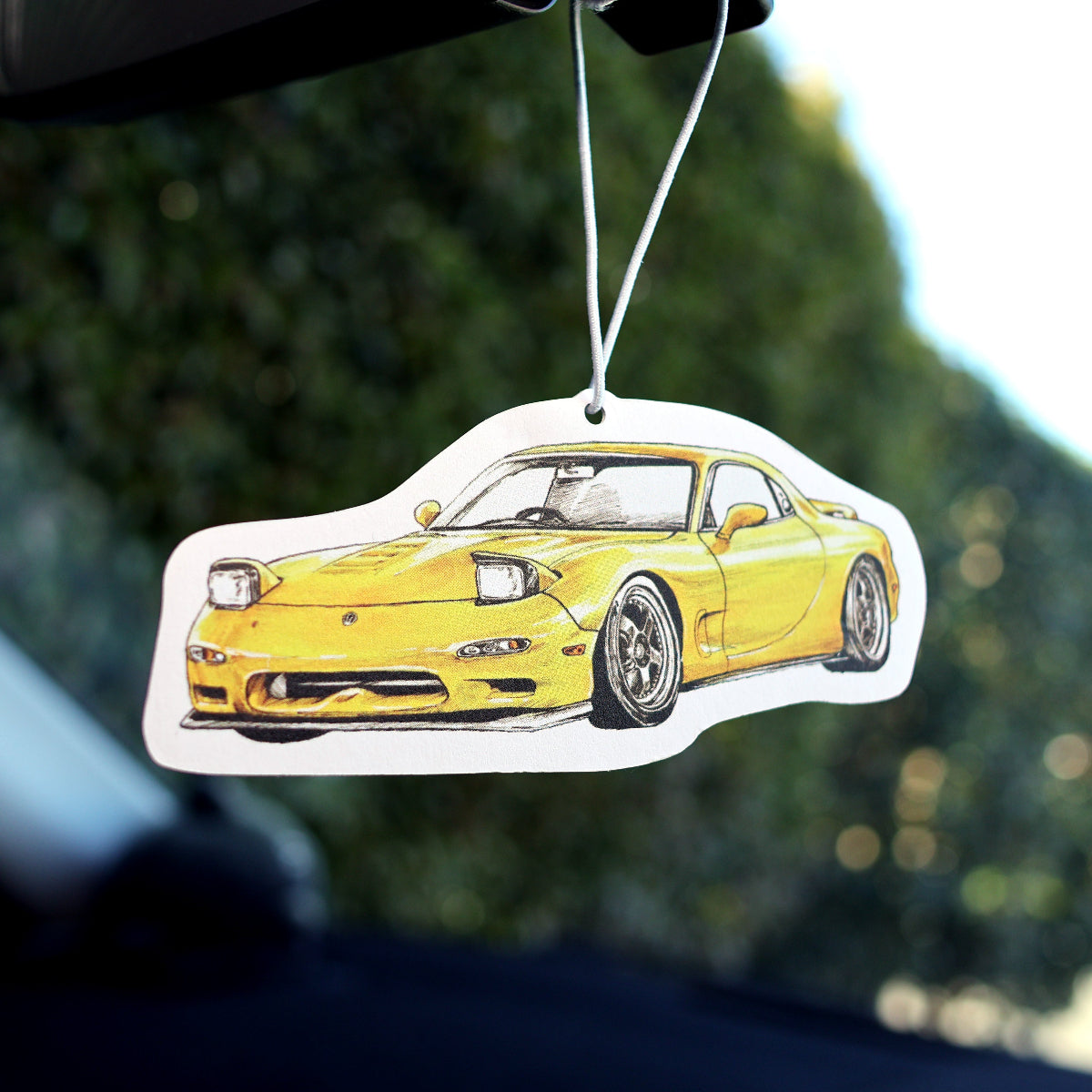 JDM-style RX-7 air freshener card with matte finish, hanging in car interior
