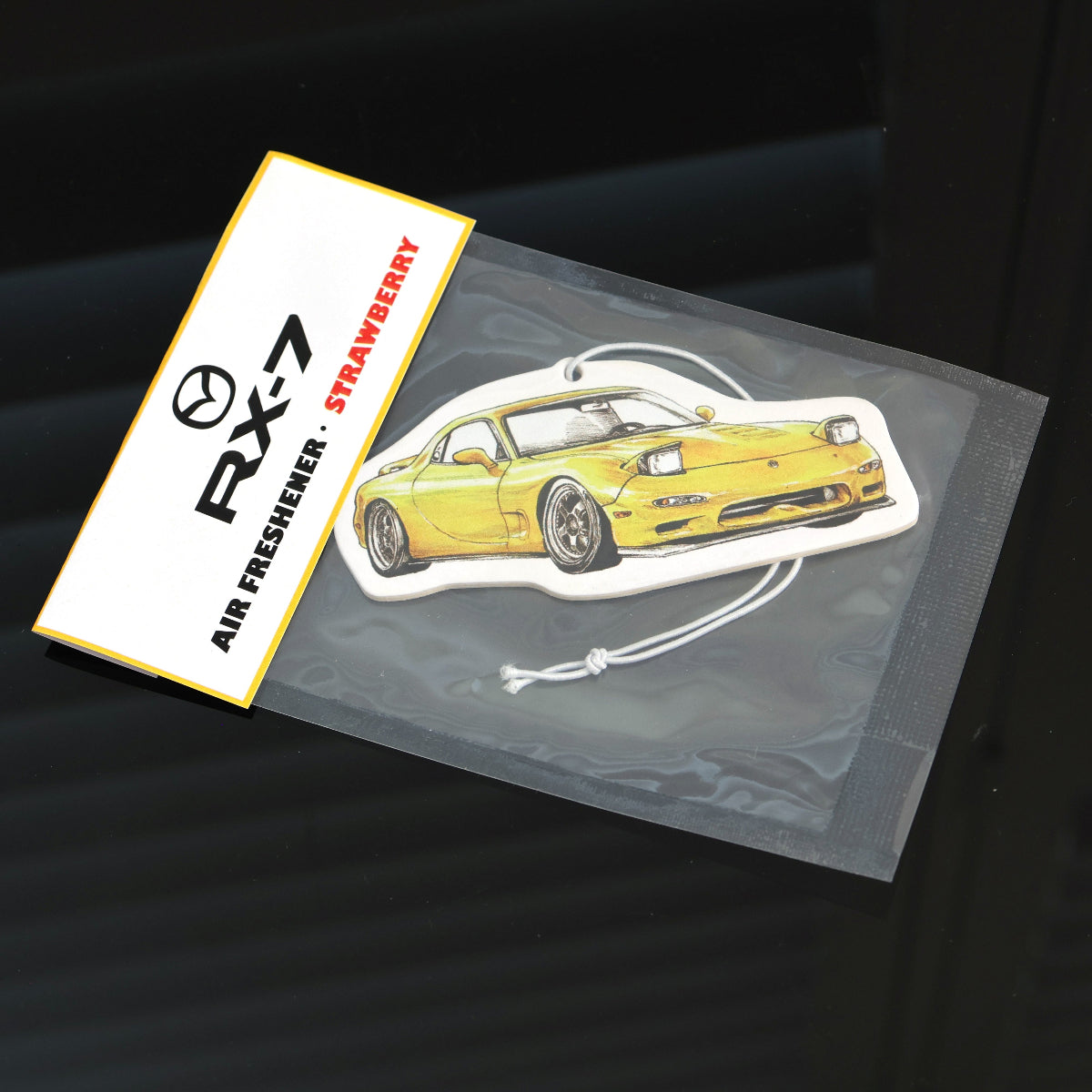 Yellow RX-7 FD air freshener in strawberry variant, ideal for rotary car fans