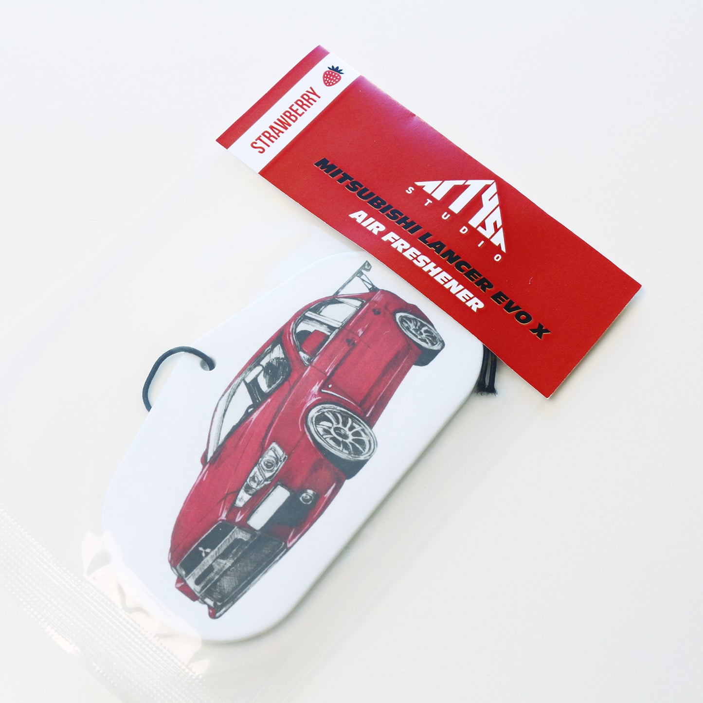 Sealed packaged EVO X car air freshener – Strawberry scent.