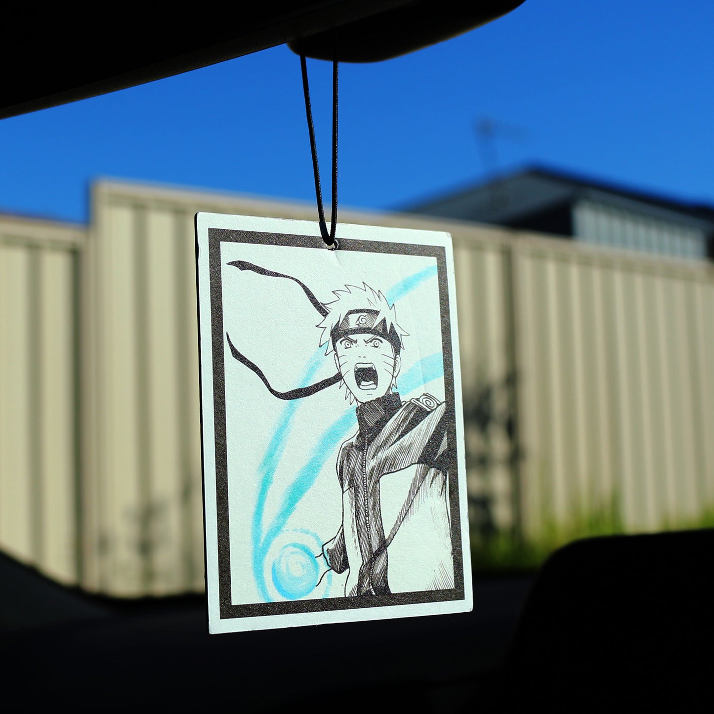 Naruto manga fan art air freshener hanging inside a car.