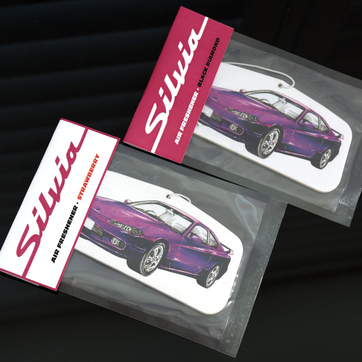 Nissan Silvia S15 air freshener individually sealed with an elastic tie for easy hanging. Available in two signature scents.
