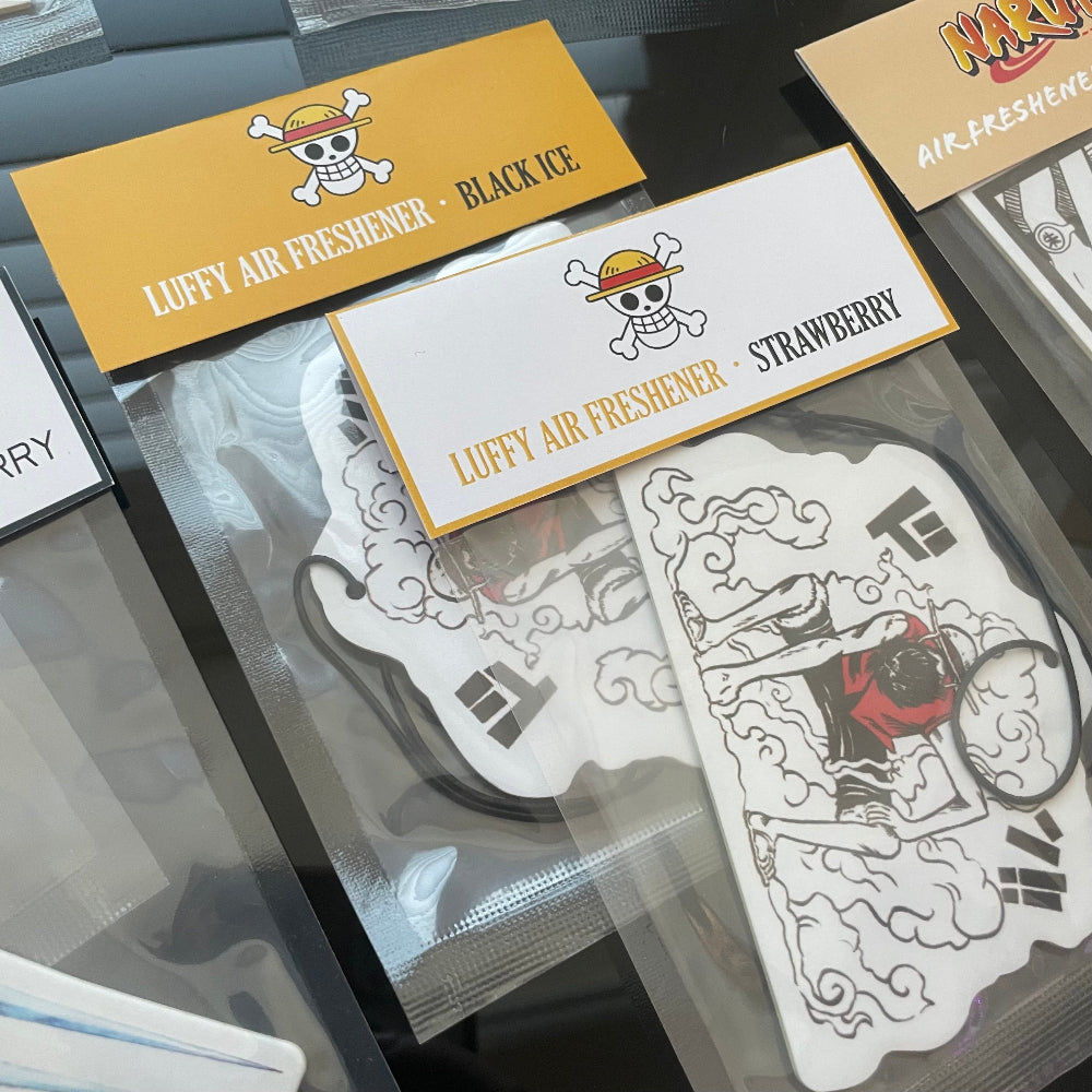 This One Piece Luffy air freshener card design is available in two refreshing scents: Black Ice and Strawberry.