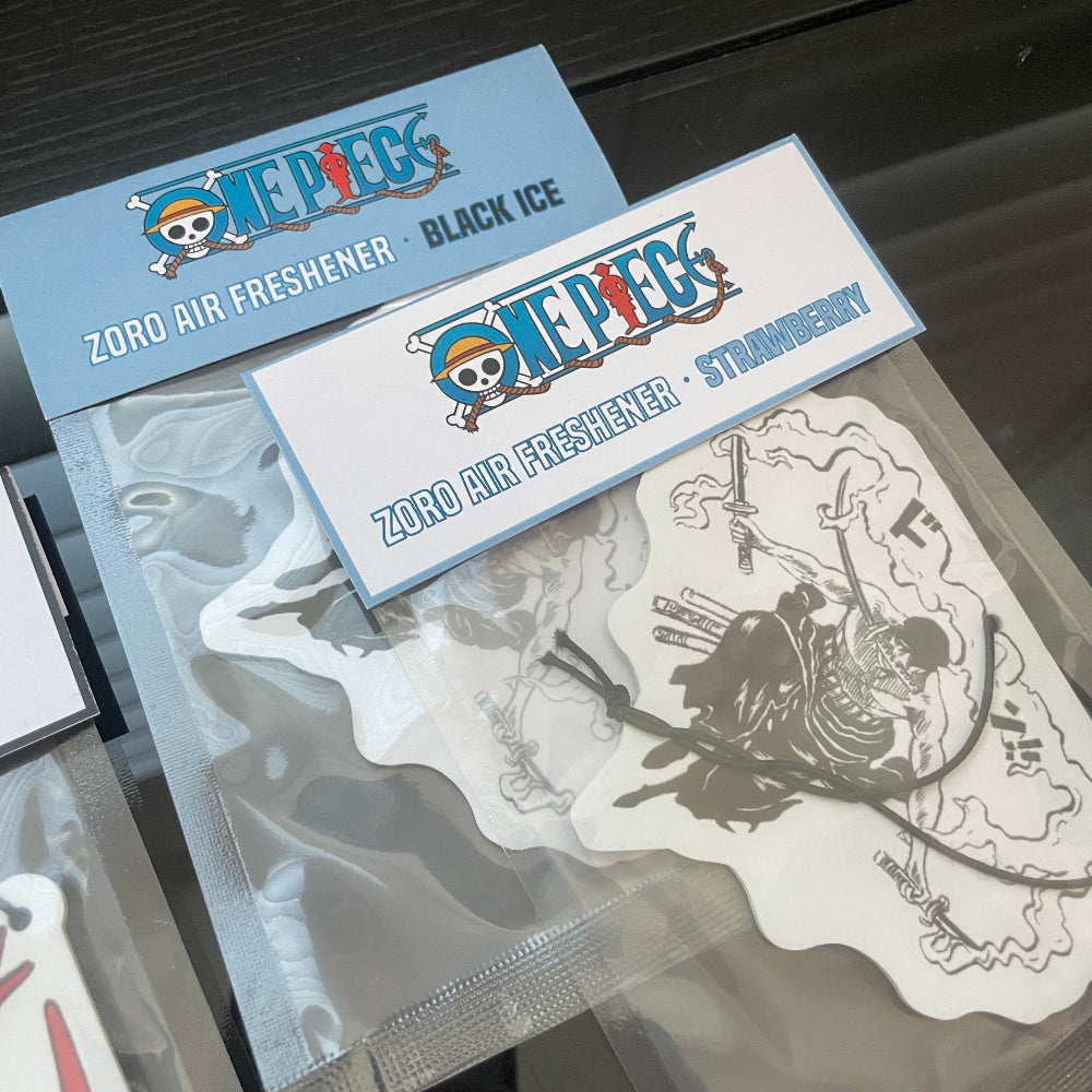 This One Piece Zoro air freshener card design is available in two refreshing scents: Black Ice and Strawberry.