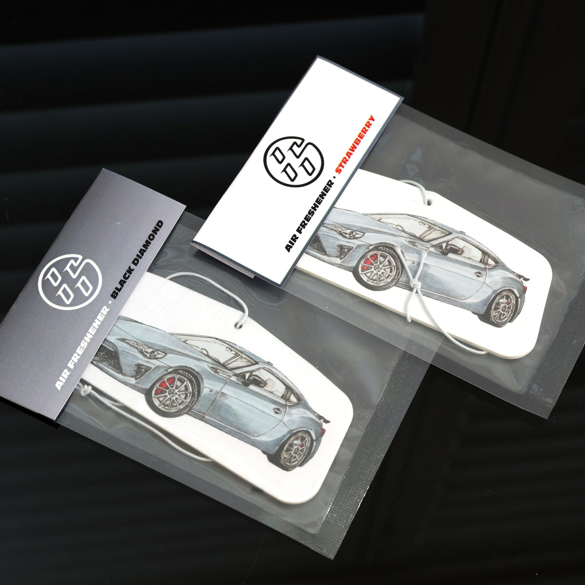 Interior car accessory, Toyota 86 air freshener with sealed packaging, available in black diamond and strawberry scents.