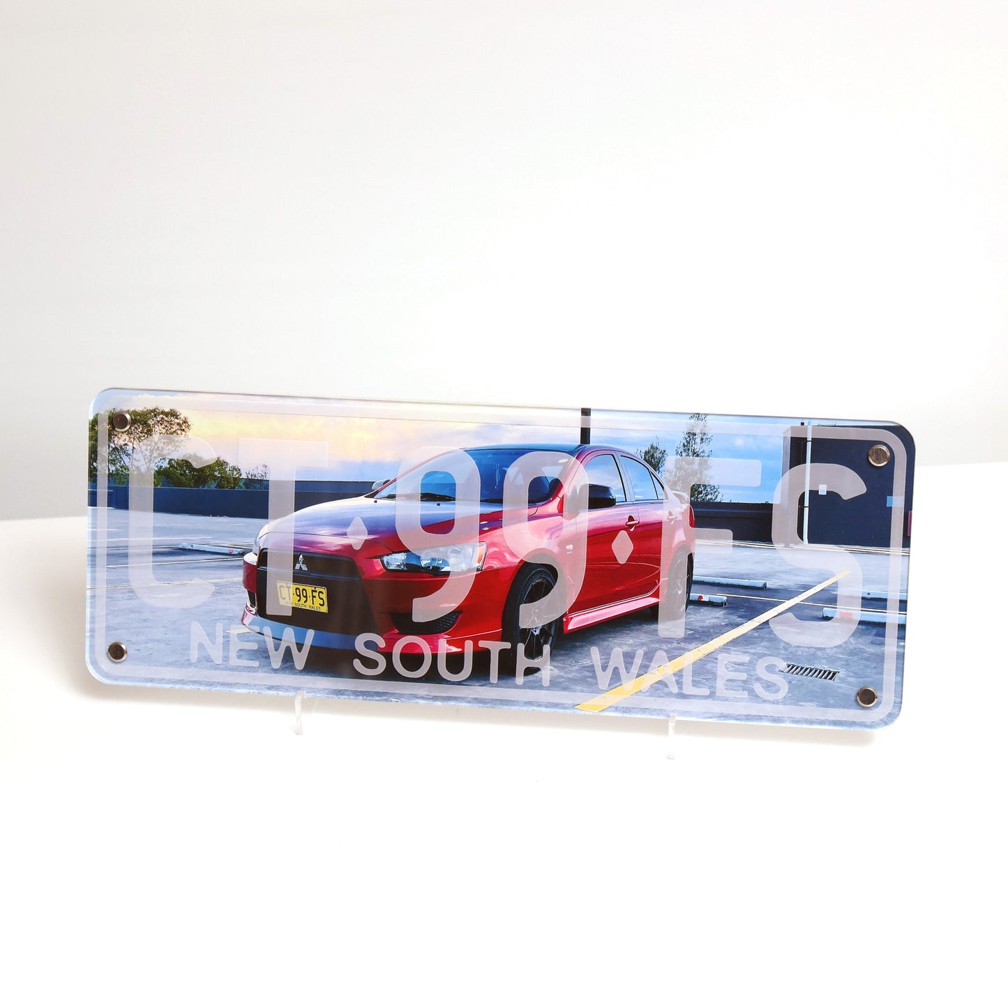 Personalized automotive wall art displayed on table featuring custom car number plate design, novelty sign style.