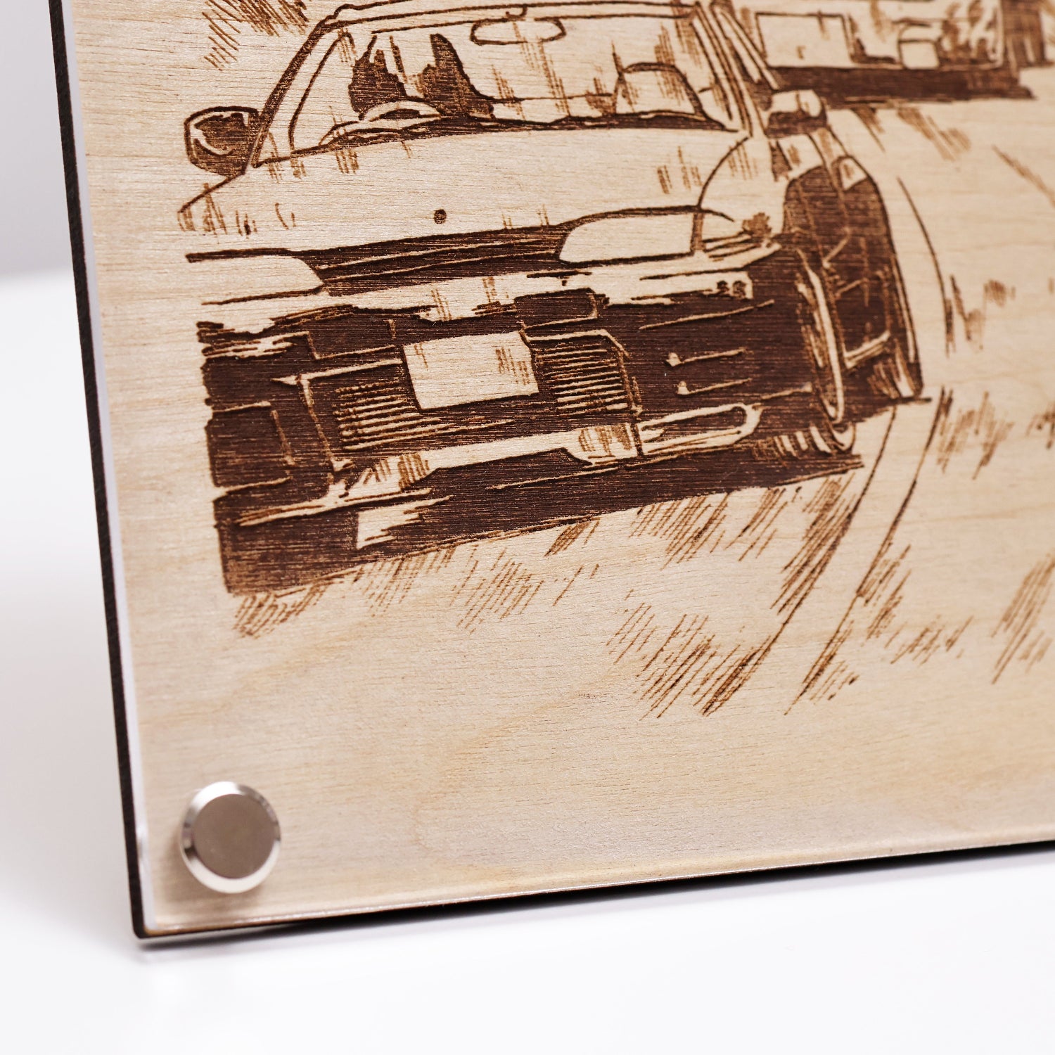 Lower left corner closeup of initial D inspired laser engraved artwork of GTR R32 drift racing AE86 in manga style.