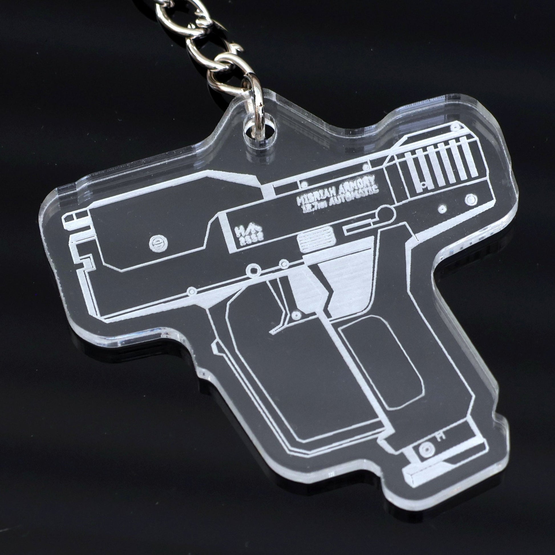Halo inspired Magnum Pistol design acrylic keychain closeup.