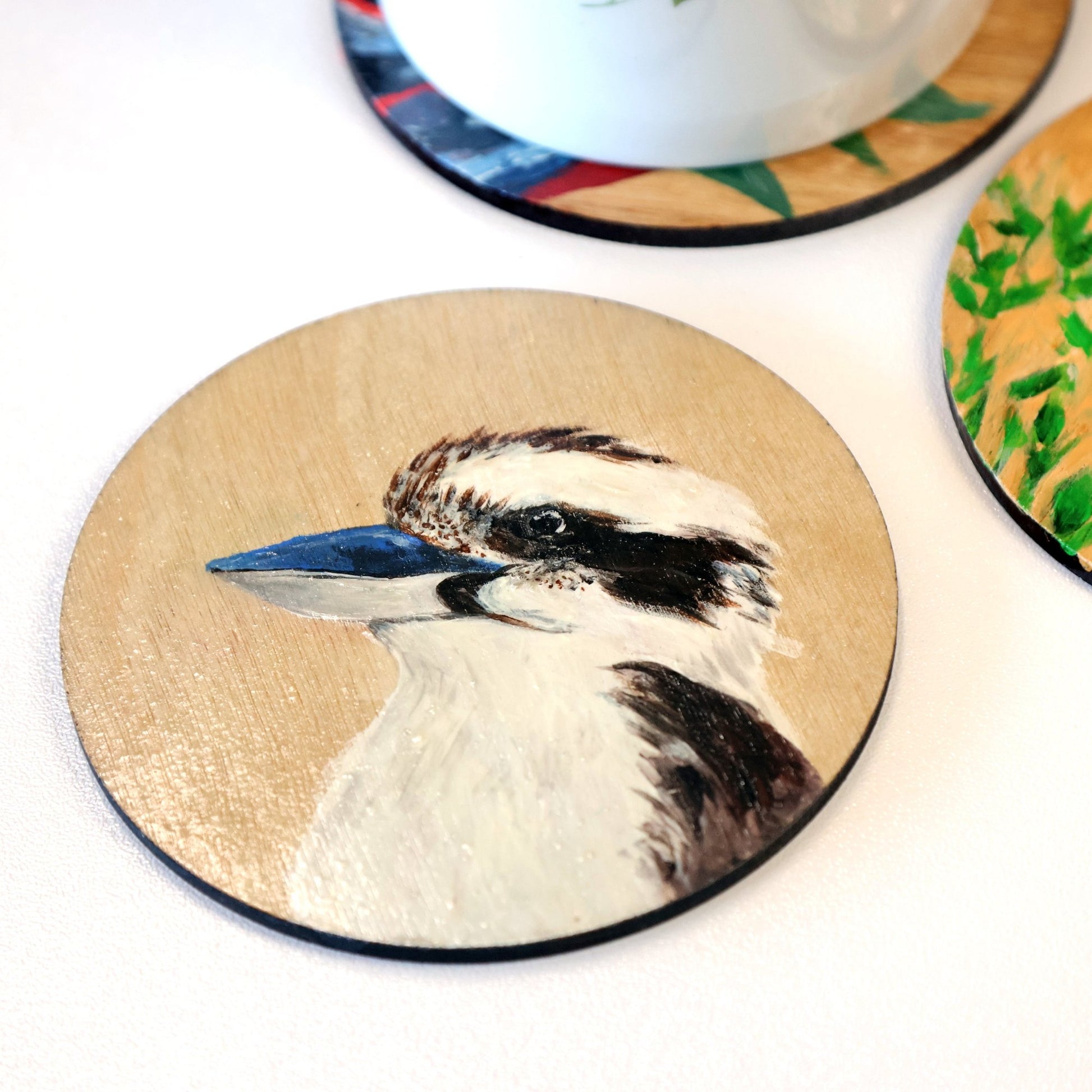 Original Australian art. Hand painted kookaburra on wooden coaster. Left side view of head and upper body. Original Australian bird artwork from Artysn Studio.