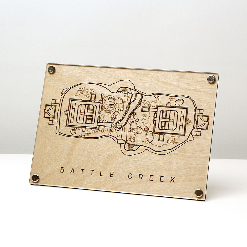 Laser‑engraved Battle Creek map displayed on table, featuring detailed etched bases and terrain inspired by the Halo multiplayer arena.