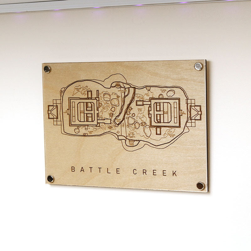 Laser‑engraved Battle Creek map displayed on wall, featuring detailed etched bases and terrain inspired by the Halo multiplayer arena.