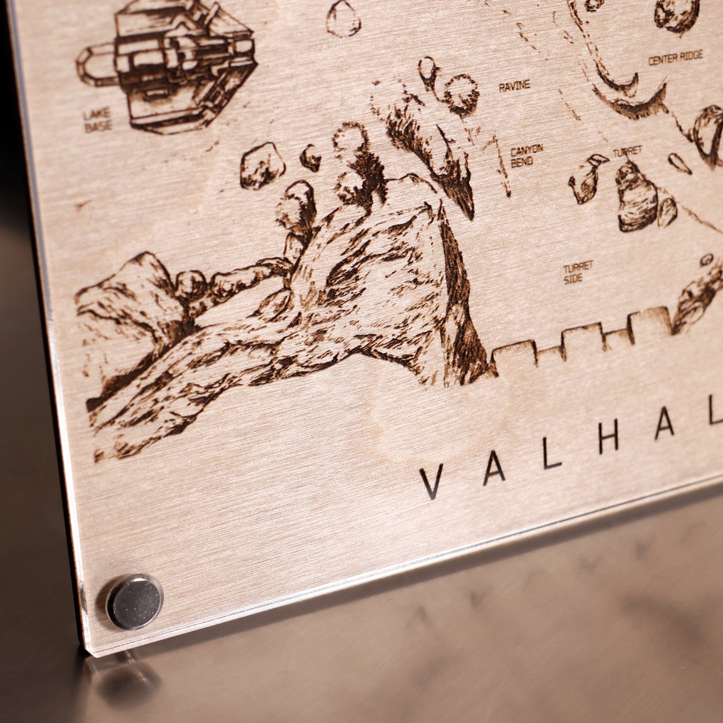 Lower left corner closeup of Halo‑inspired Valhalla map art with engraved terrain details in a minimalist LayaBoard frame.