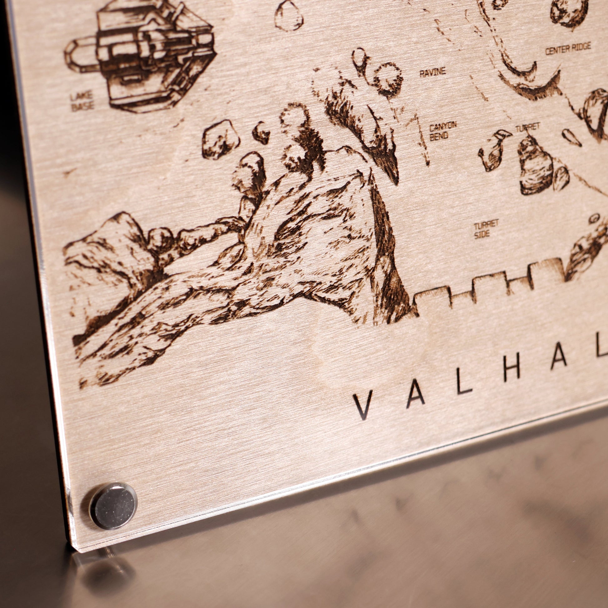 Lower left corner closeup of Halo‑inspired Valhalla map art with engraved terrain details in a minimalist LayaBoard frame.