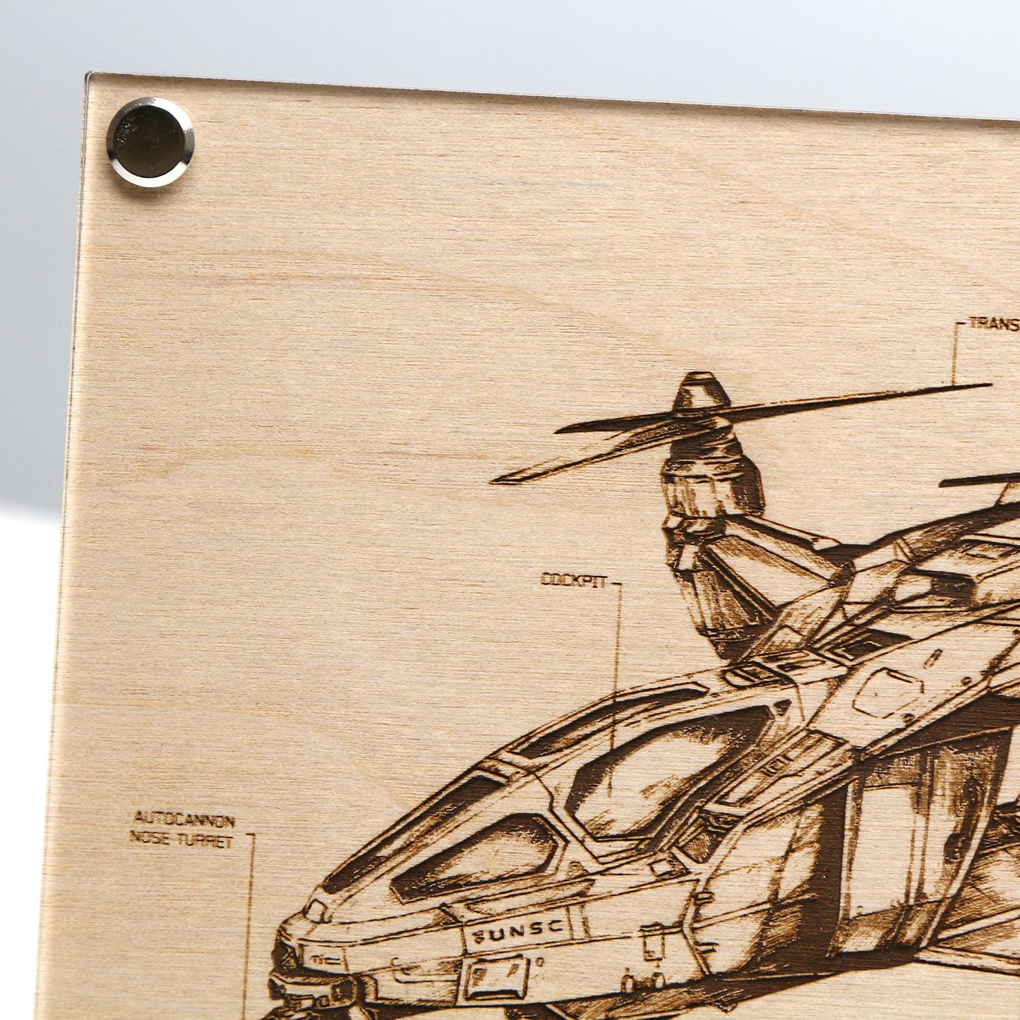 Top left corner closeup of laser‑engraved UH‑144S Falcon blueprint on LayaBoard featuring aircraft linework and UNSC‑style technical annotations inspired by Halo.