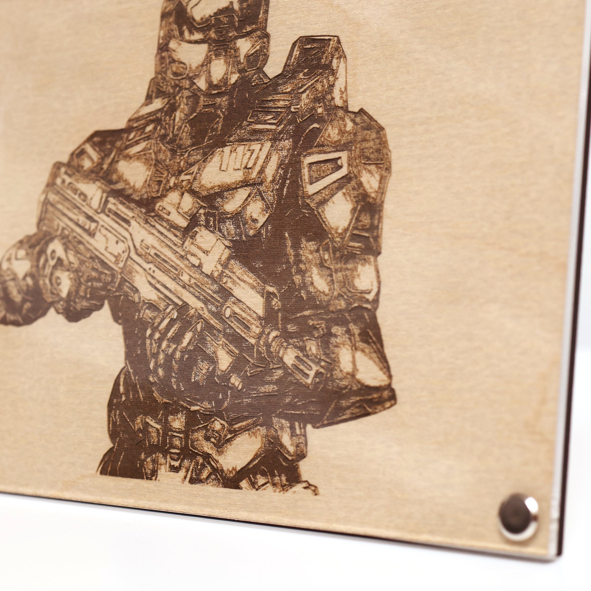 Close‑up on lower right corner of engraved Halo Master Chief portrait with wood frame