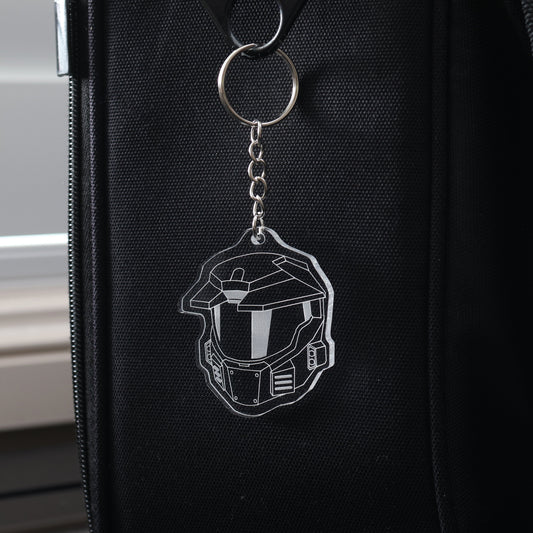 Clear acrylic keyring featuring Halo Master Chief Helmet Mark V design, photographed on black carry bag