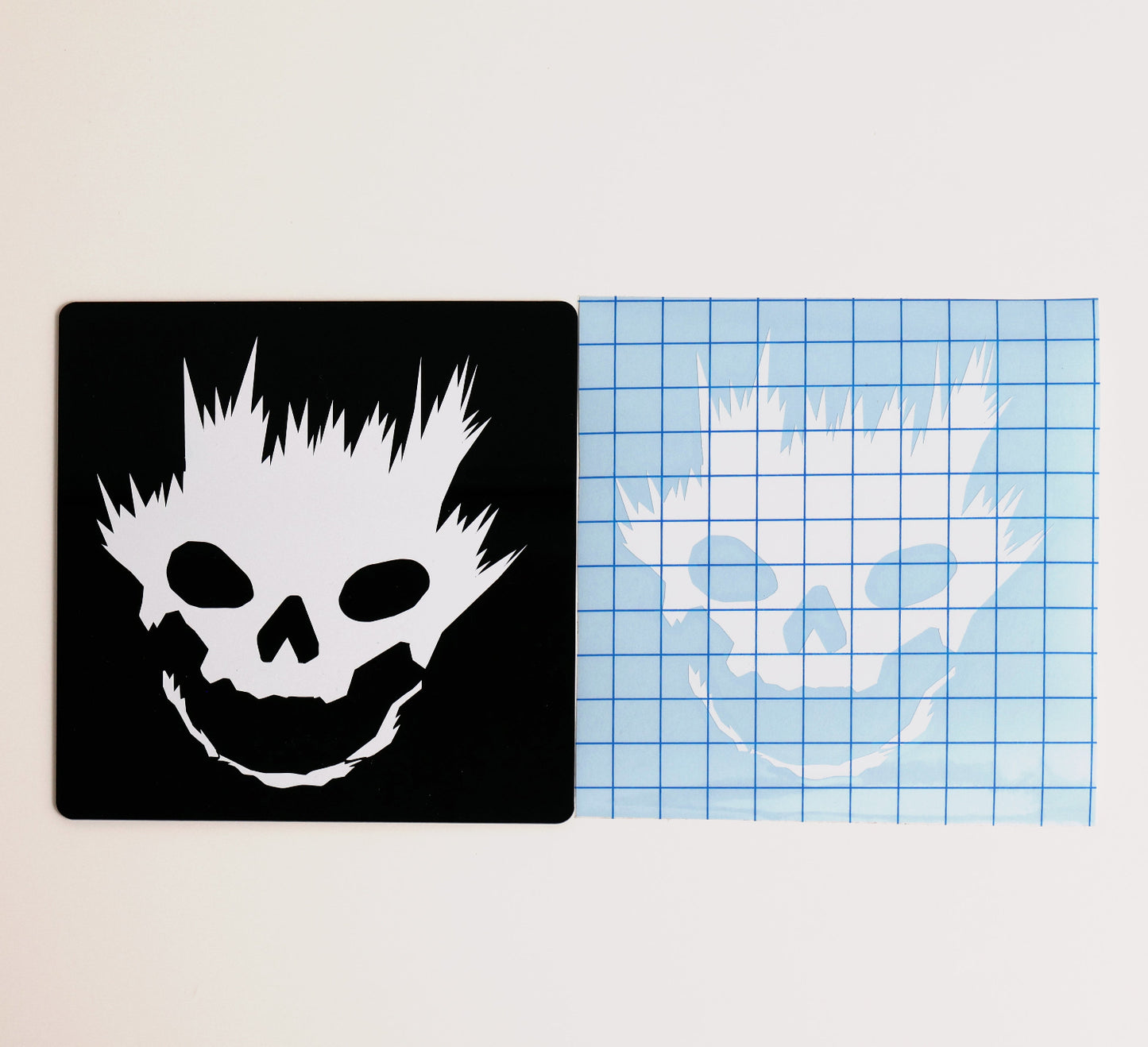 Entransing's stylized Halo Emile skull helmet decal in white vinyl, side by side with transfer tape sample.