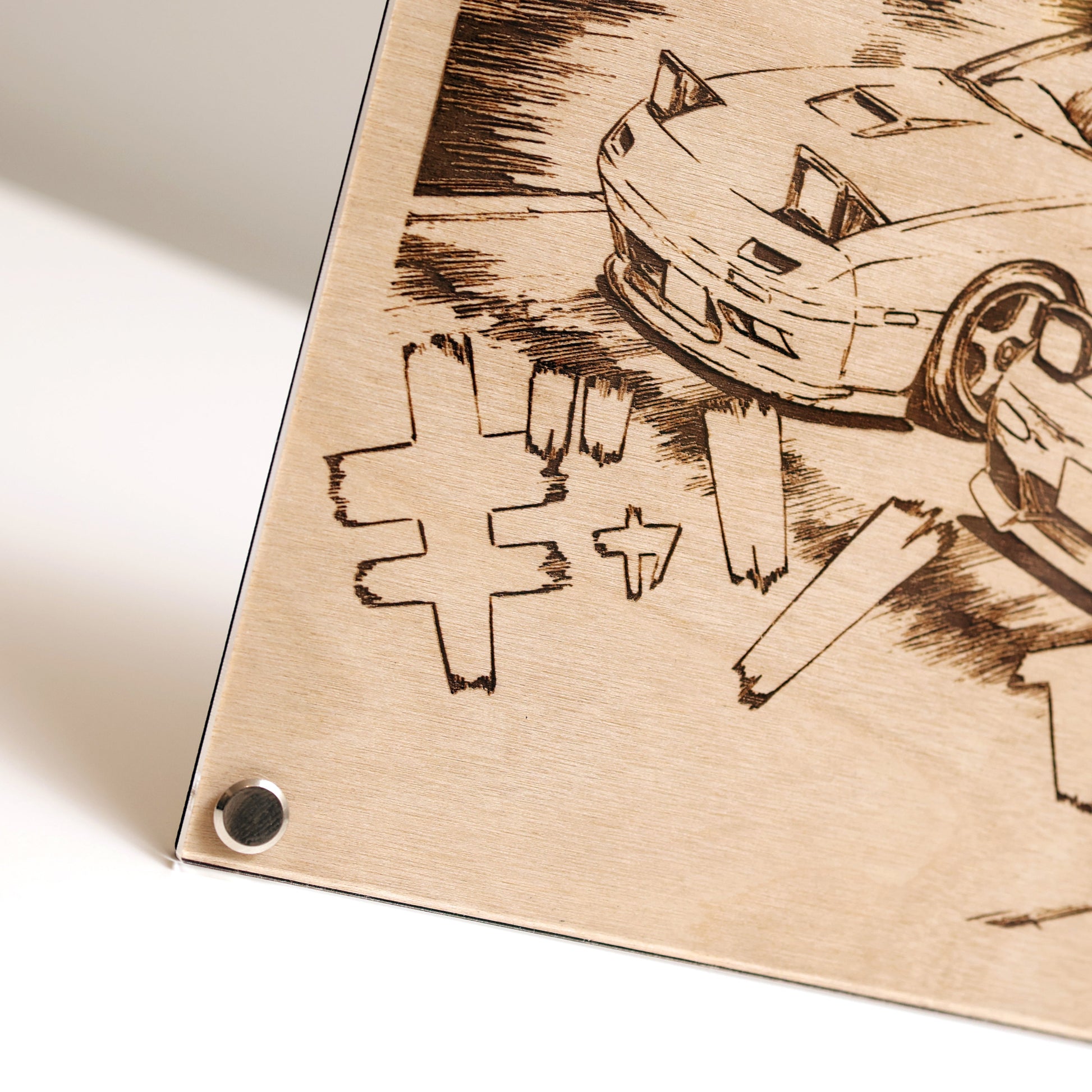 Bottom left corner close-up of wooden plaque with laser-engraved design of 2x RX-7 and text on a white background