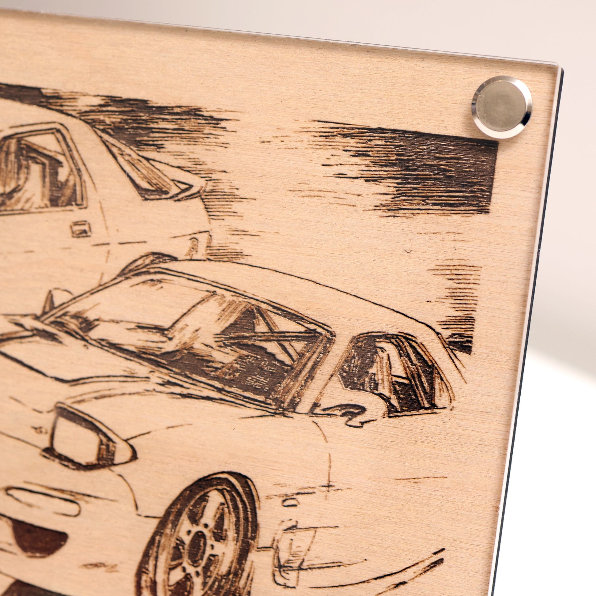 Top right corner close-up of wooden plaque with laser-engraved design of 2x RX-7.