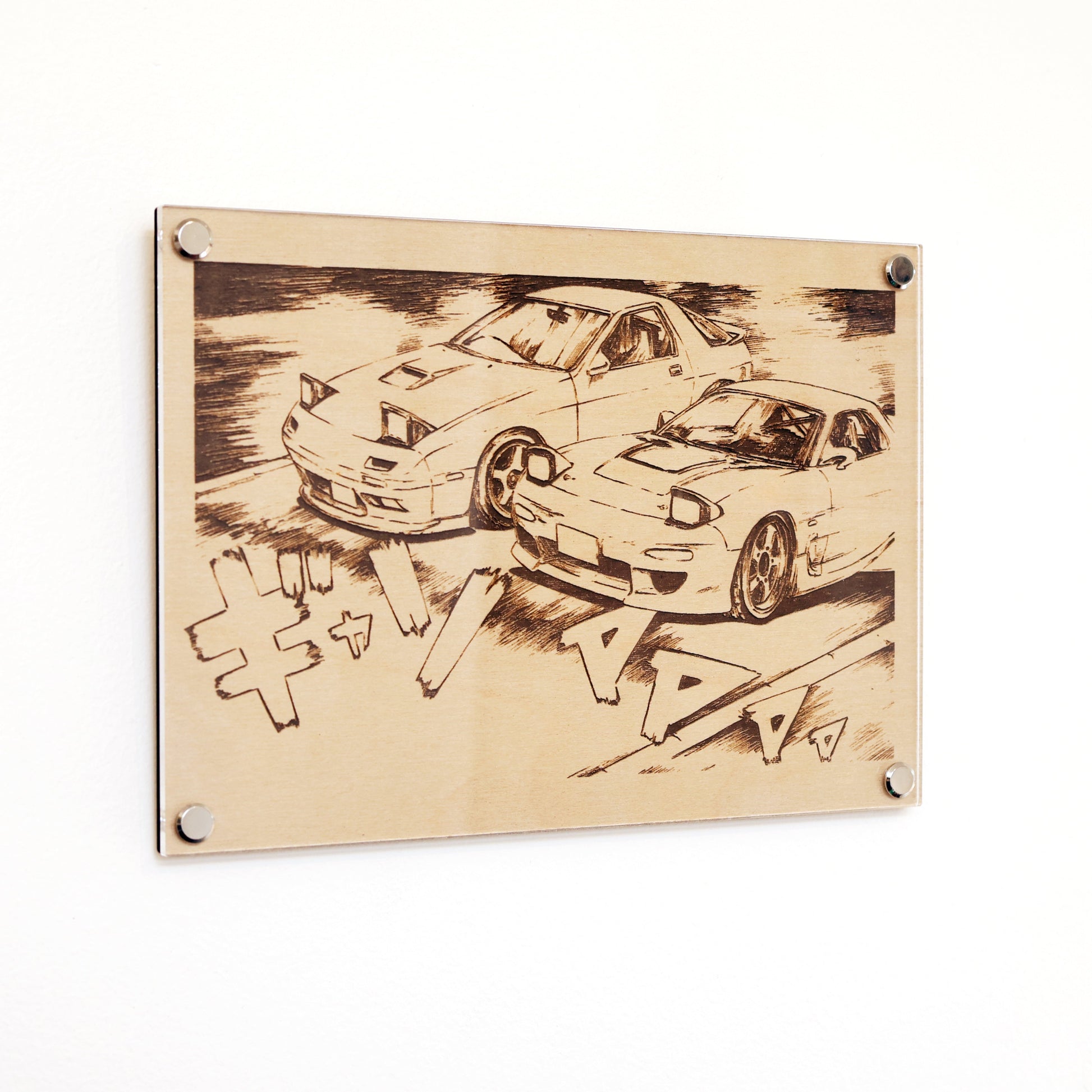 Laser-engraved artwork displayed on wall featuring iconic Mazda RX-7 FC3S and FD3S with Japanese text inspired by Initial D.